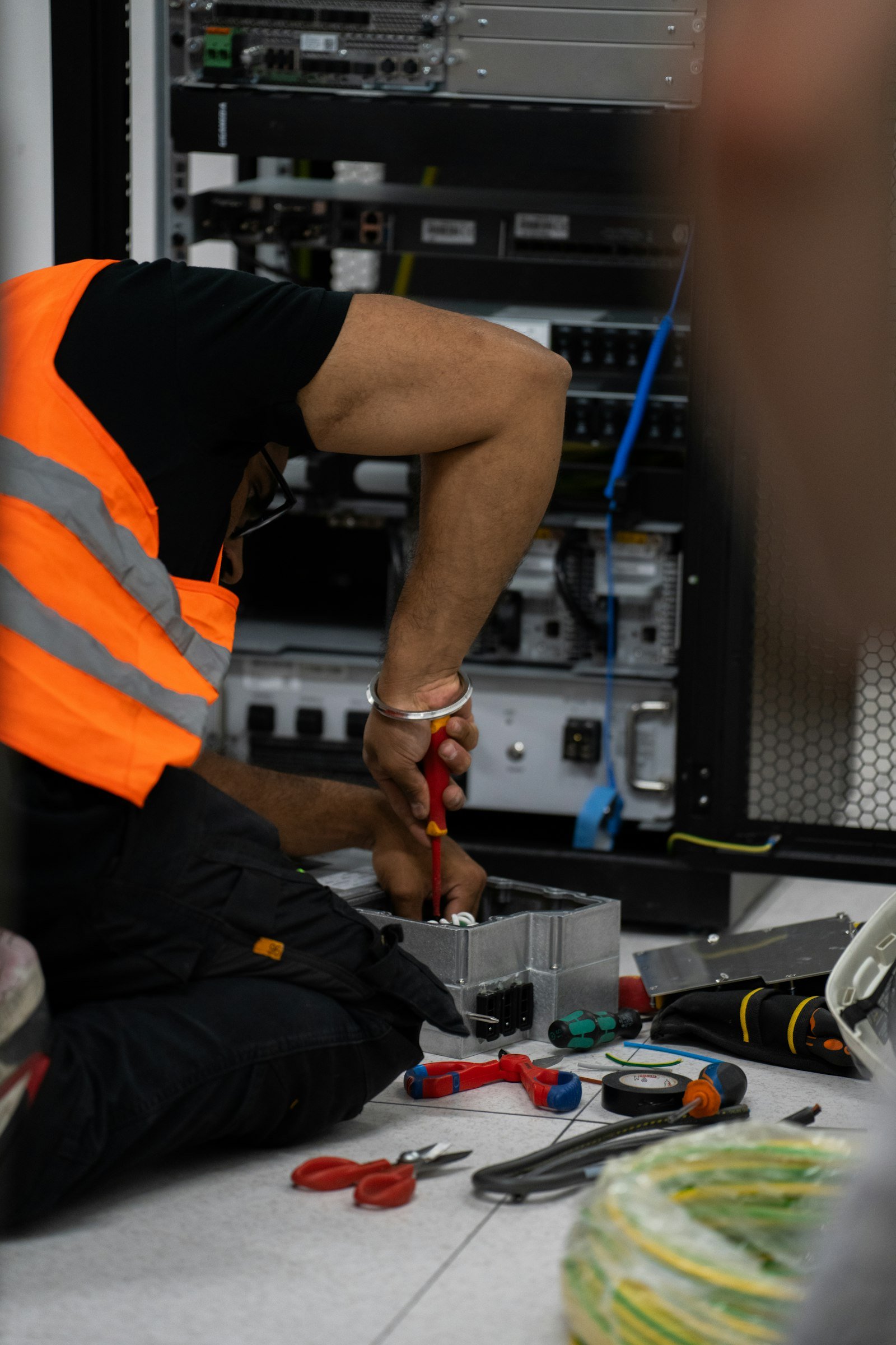 Technician working hands-on with network and server equipment